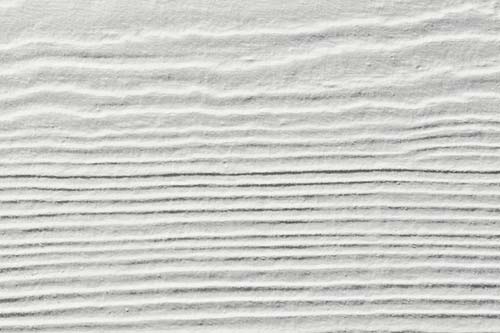 Closeup of white siding with texture